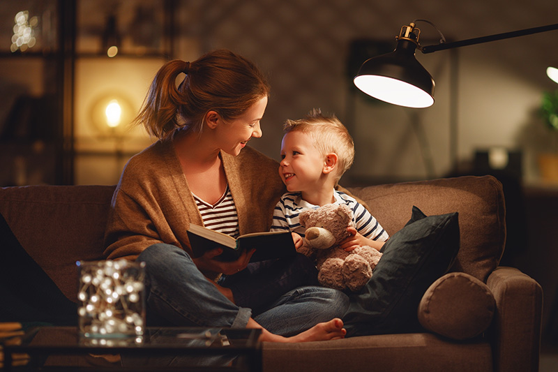 mother-son-reading-by-lamp-264239850